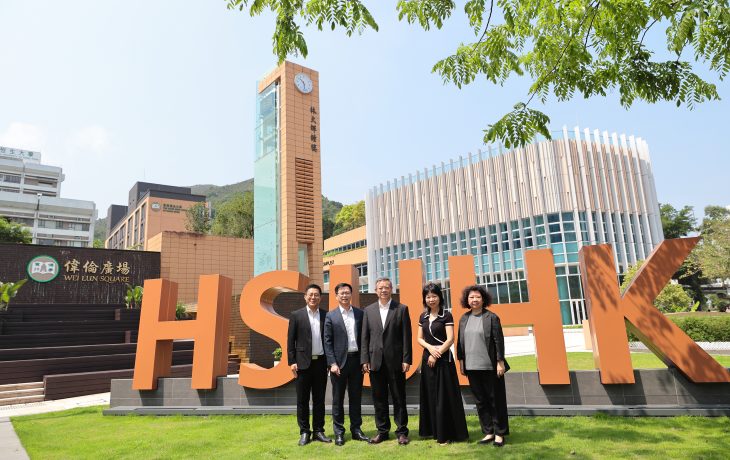 Delegates from Foshan University at the Wei Lun Square, in front of the abbreviation of the University.