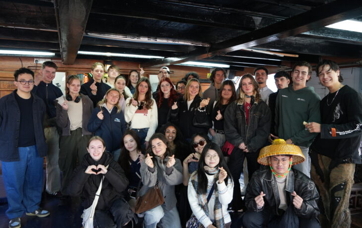 Exchange students on board a traditional fishing boat