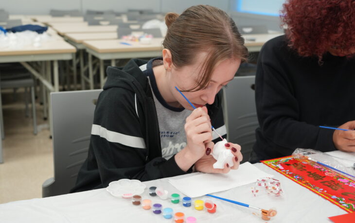 Students learn to paint the Fortune Cat with creativity.